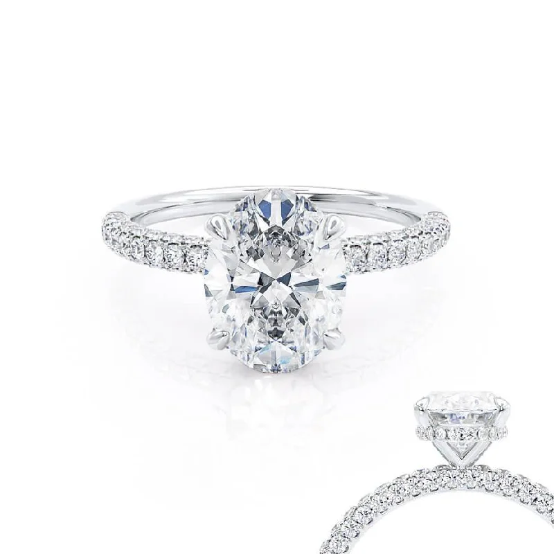 Solitaire diamond engagement ring with a platinum setting for a classic and elegant lookCOCO - Oval Moissanite & Diamond Platinum Petite Hidden Halo Triple Pavé Shoulder Set Ring