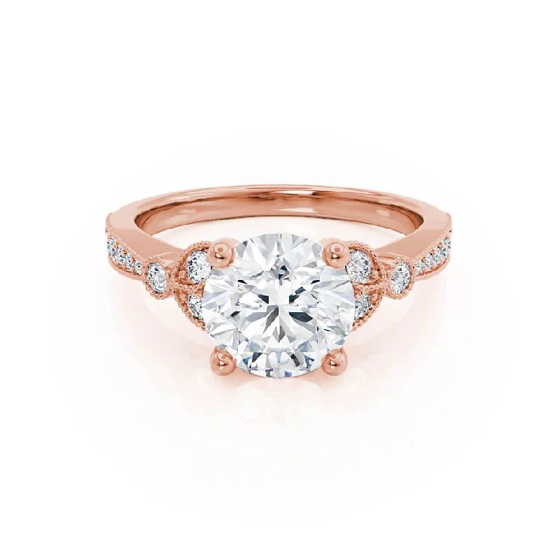 Round - cut diamond engagement ring with a twisted band design in 14K white goldLILIANA - Round Moissanite & Diamond 18k Rose Gold Shoulder Set Ring