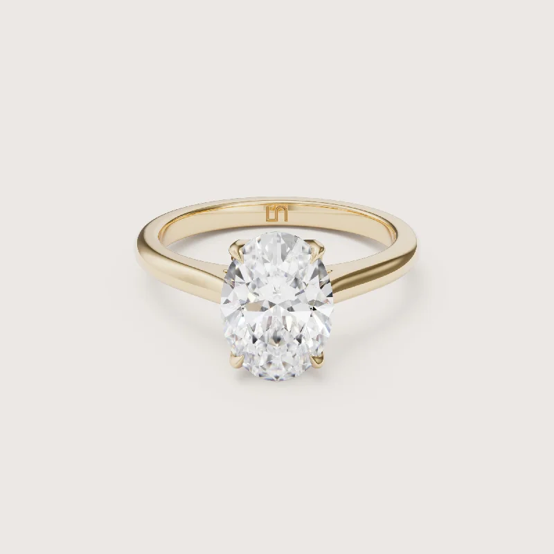 Pear - shaped diamond engagement ring with side baguette diamonds in 18K goldAstar Oval Cathedral