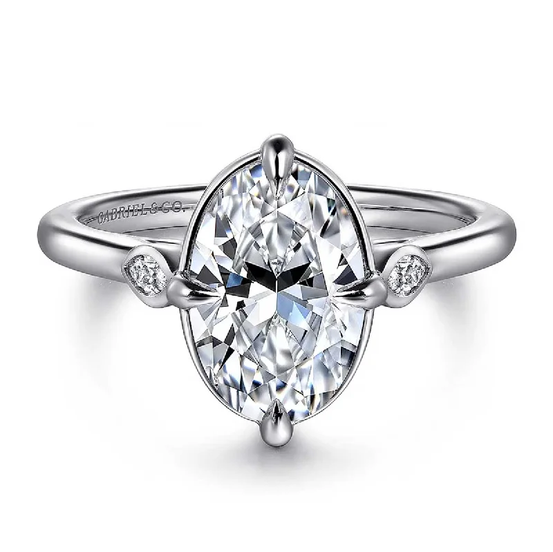 Halo diamond engagement ring in 18K white gold with a center oval - cut stoneCharli Oval Diamond Engagement Ring Setting with Side Diamonds