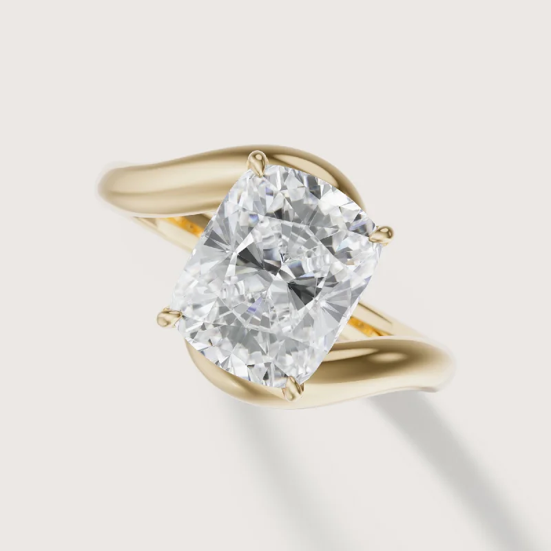 Three - stone diamond engagement ring in rose gold, symbolizing past, present, and futureIsola Cushion Solitaire