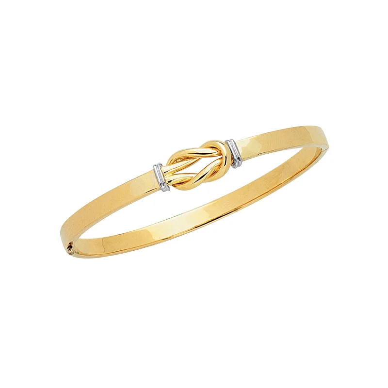 Radiant - cut diamond engagement ring with a bezel - set center stone in 18K yellow goldPolished Yellow & White Gold Knot Bangle