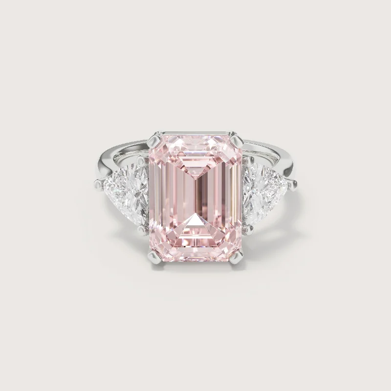 Three - stone diamond engagement ring in rose gold, symbolizing past, present, and futureAnais Pink Emerald Trilliant Trilogy