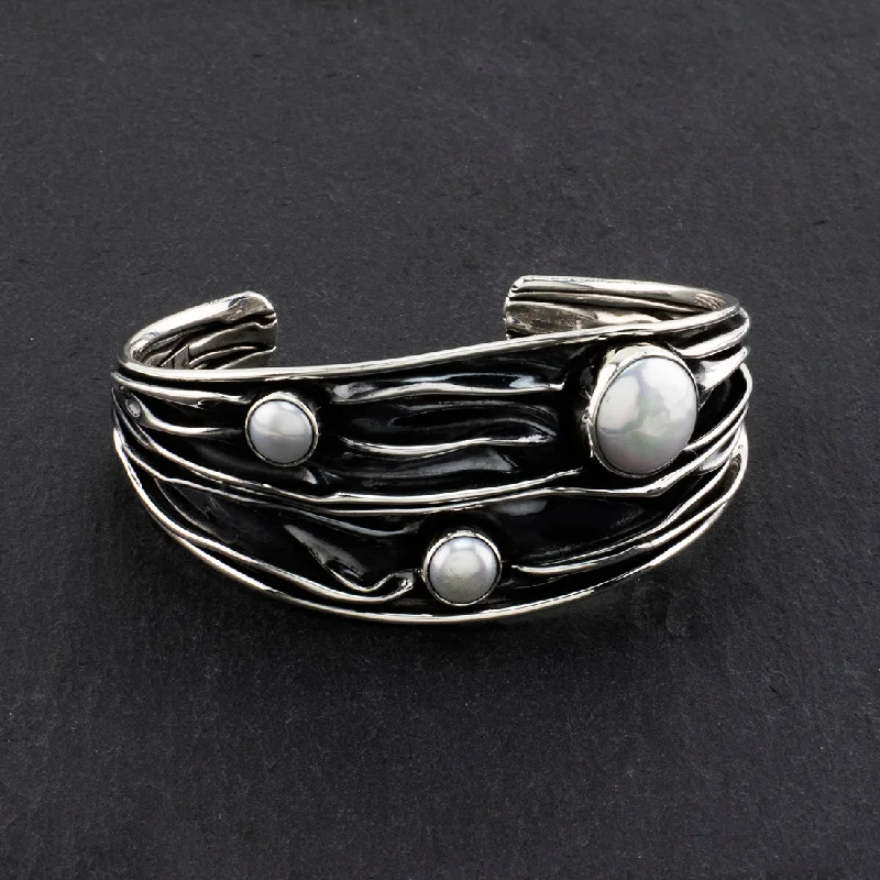 Women's Cuff Bracelets with Celtic Knot Patterns for a Mysterious and Cultural AppealWide Corrugated Silver and Pearl Cuff Bracelet